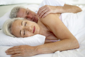 mature man and woman in bed