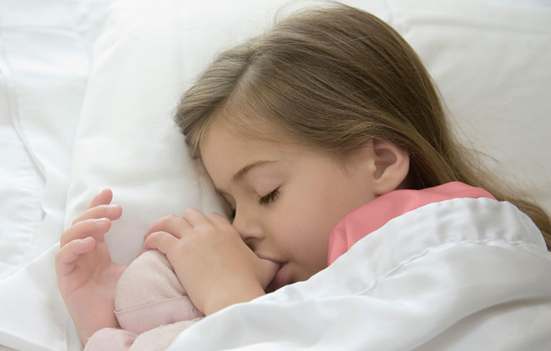 little girl sleeping sucking her thumb